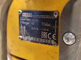 a close up of a yellow machine with a label on it