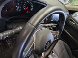 a steering wheel and dashboard of a car in a car showroom