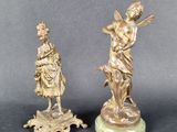 paire de figurines anciennes en bronze représentant une femme et un homme
