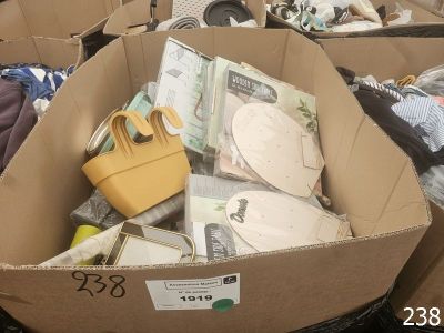 a cardboard box filled with assorted items in a room