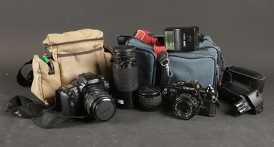many different types of cameras and their bags on the table