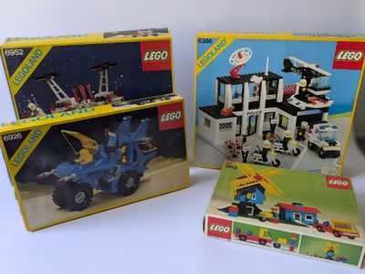 Deux boîtes de legos sont posées l'une à côté de l'autre sur une table.