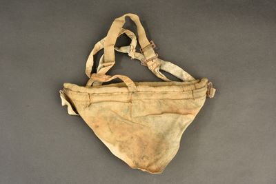 an old bag with a strap hanging from it ' s side