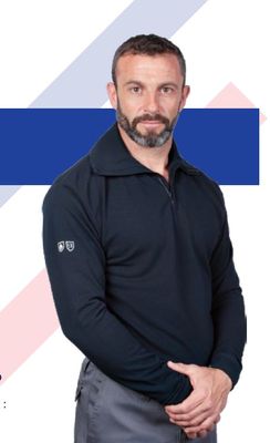 a man that is standing in front of a blue and white background