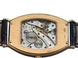 an image of a gold wrist watch with a black leather strap