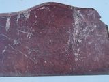 a red marble plaque on a white surface