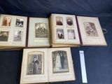 several old photos of people are displayed on a table