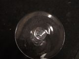 a wine glass sitting on top of a black table