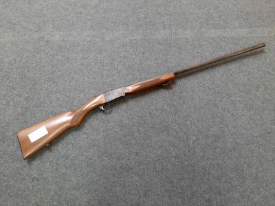 a rifle that is laying on a table