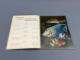 an open book with a picture of a fish on it