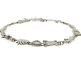 a close up of a silver bracelet on a white background