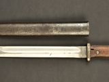 two knives that are laying side by side on a table
