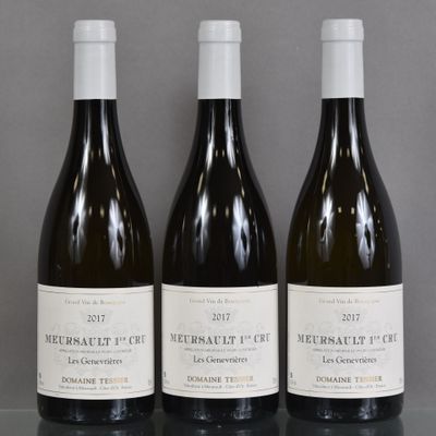 three bottles of wine are lined up on a table