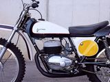 a white and black motorcycle parked in front of a wall