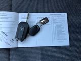 a car key and a car keychain on top of a book