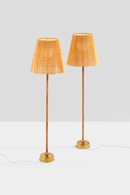 a pair of bamboo lamps on a table with a white background