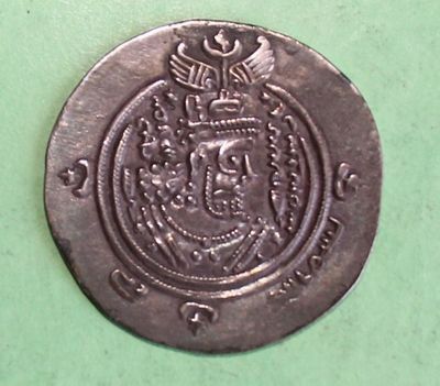 an old silver coin with a coat of arms and a crown on it