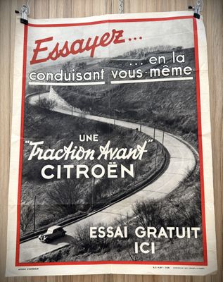 an old poster hangs on a wooden wall in a room