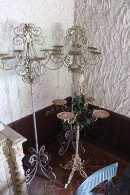 a table with three candles on it in the corner of a room