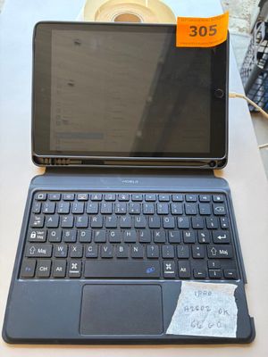 a laptop computer sitting on a table with a price tag on it