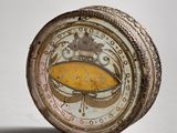 a close up of a small clock with a crown on it