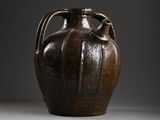 a brown vase that is sitting on a table