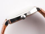 an image of a close up of a watch on a white surface