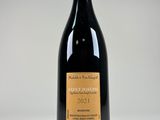 a close up of a bottle of wine on a white surface