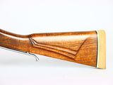 a close up of a rifle on a white surface with a white background