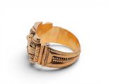 an image of a close up of a gold ring on a white surface