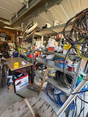 a garage with a lot of tools and a lot of clutter