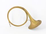 an antique brass french horn with a brass bell on a white background