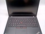 a black laptop with a red button on the keyboard