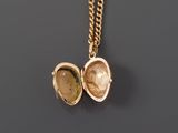 a close up of a gold locke with a chain around it