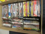 a lot of dvd ' s on a shelf in a box