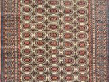 an antique persian rug with a geometric design and fringe fringes