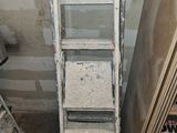 a ladder that is leaning against a wall in a room