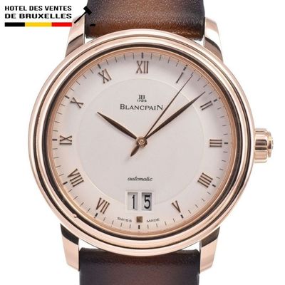 a close up of a watch with roman numerals on the face