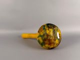yellow and green marbled glass knob on a yellow wooden stick