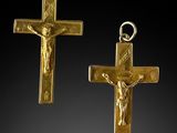 two gold cross pendants with jesus on the cross