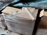 a pile of boxes sitting on the floor next to a wall