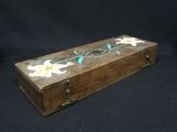 a small wooden box with flowers painted on it