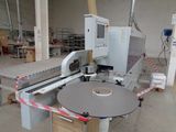 a machine that is cutting a piece of paper on a table