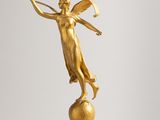 an image of a gold statue of a woman holding a tennis racquet