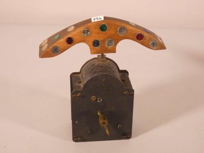 a clock that has a wooden handle on top of it