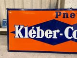 an orange and blue sign that says kleber - cola on it