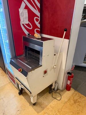 a machine that is sitting on the floor next to a coke machine