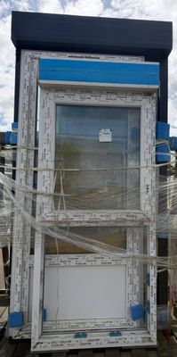 a picture of a blue and white phone booth in a yard