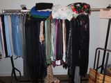 a rack of clothes and a guitar in a room