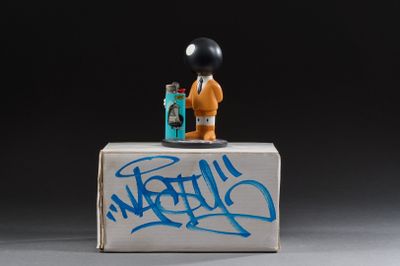 a toy that is sitting on a box with graffiti on it